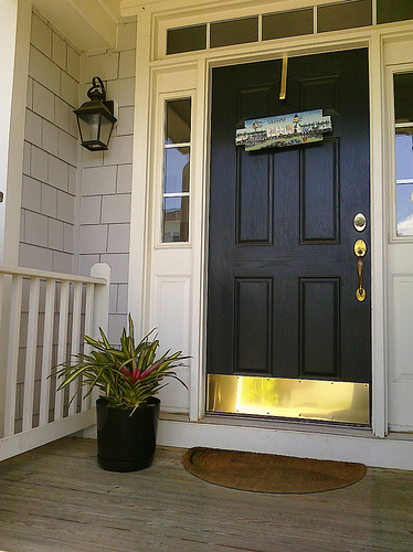 An entry door with brass kick plate, photo courtesy Michelle Rebecca